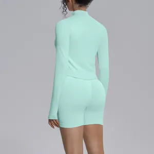 Mint green seamless long sleeve crop top and shorts activewear set for fitness and yoga gym.
