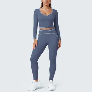 Blue long sleeve yoga set, matching crop top and leggings with stylish white contrast piping.