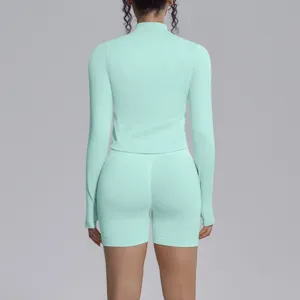 Mint green seamless long sleeve activewear set with high waist shorts for fitness yoga.