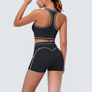 Back detail view of black athletic two-piece yoga set with white contrast piping, activewear.