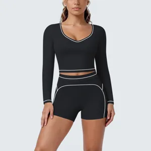 Detailed closeup view of the black activewear set featuring stylish contrast white piping.