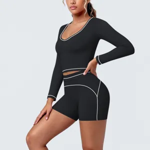 Black long sleeve sports yoga crop top and shorts set with contrast piping for fitness.