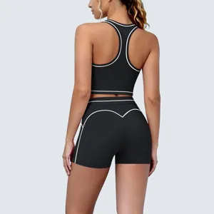 Detail view of the back of black athletic sports bra and shorts set with white piping.