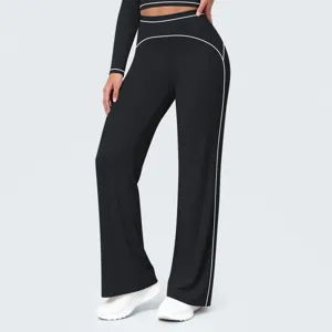 Detail view of black high-waist wide-leg athletic pants featuring stylish white contrast piping.