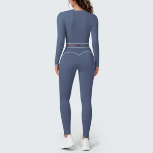 Back view details of long sleeve athletic crop top and matching leggings activewear set.