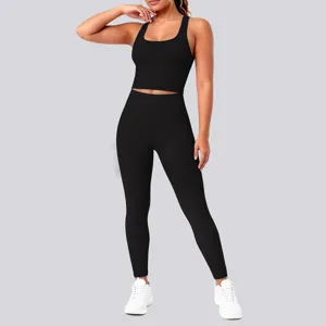 Women solid black activewear yoga set featuring a crop top and high waist leggings for fitness.