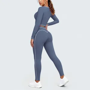 Detailed back view of the blue long-sleeve crop top and yoga leggings with white trim.
