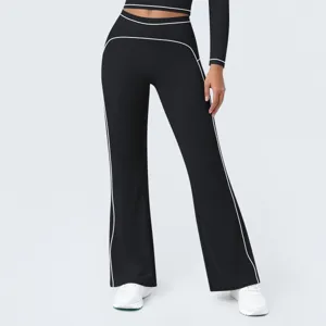 Close-up detail of black high-waist athletic flare pants featuring contrast white piping.