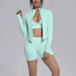 Detail view of mint green seamless 3-piece activewear set, zip jacket, sports bra, shorts.