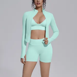 Mint green seamless activewear set detail, long sleeve zip jacket, bra and shorts.