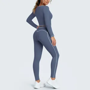 Back detail of women long sleeve yoga crop top and high waist leggings set with contrast piping.