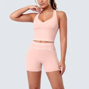 Close-up detail of women pink yoga set showing contrast piping and soft racerback style.