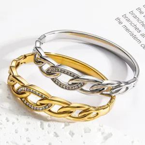 Detailed close-up of dual-tone metal knotted rhinestone bangle bracelets with secure clasp.