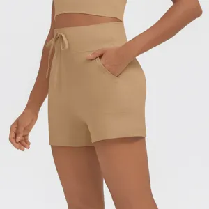 Detail view of khaki high-waist athletic shorts featuring side pockets and adjustable drawstring.