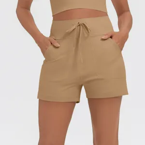 Khaki high-waisted drawstring athletic shorts featuring dual side pockets, close-up view.