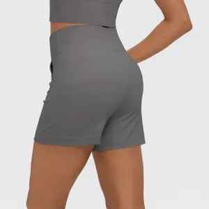 Detail shot of women's high-waisted athletic shorts in dark grey with side pockets.