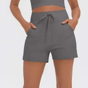 Detail shot of grey high waist drawstring workout shorts with side pockets, casual fitness style.