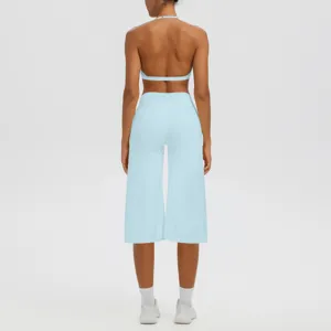 Détails de vue arrière du soutien-gorge de yoga licou bleu clair et pantalon de fitness capri.
