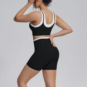 Women's two-piece yoga set featuring a contrast color sports bra and high-waist shorts.