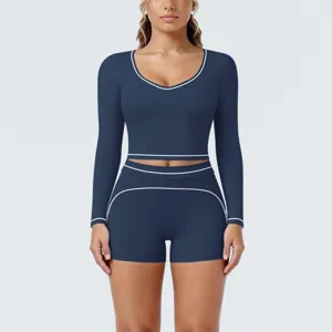 Dark blue long sleeve cropped yoga top and matching shorts activewear set for fitness workout.