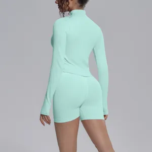 Mint green seamless long sleeve top and high waist sports shorts fitness activewear set detail.