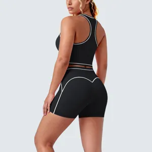 Detailed view of black sports bra and yoga shorts set with white piping and racerback design.