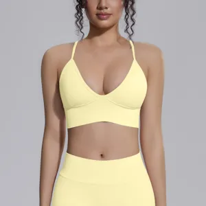 Yellow seamless sports bra and yoga leggings detail shot, breathable stretch fitness wear.