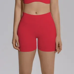 Close-up of seamless ribbed high-waist yoga shorts in vibrant red, perfect activewear detail.