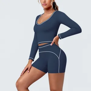 Detailed close-up view of the dark blue activewear top and shorts with white piping detail.