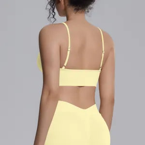 Seamless ribbed sports yoga set in yellow, featuring a supportive bra and high-waisted leggings.
