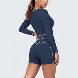 Women athletic long sleeve crop top and shorts yoga set activewear outfit for fitness workout.