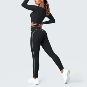Detail view of black yoga activewear set featuring contrast white piping and tight fit.