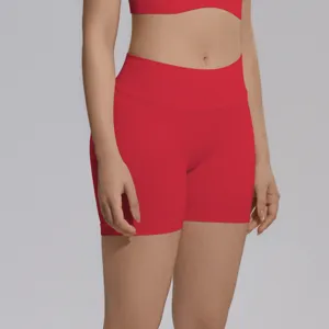 Close-up view of red seamless high-waist yoga shorts on model, highlighting comfort and fit details.