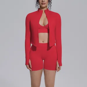 Red seamless activewear detail showing zip jacket, bra and shorts set for gym fitness.