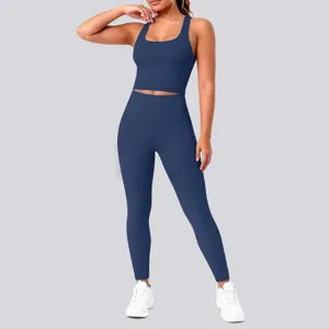 Detail view of solid dark blue yoga set, featuring crop top and high-waisted leggings.