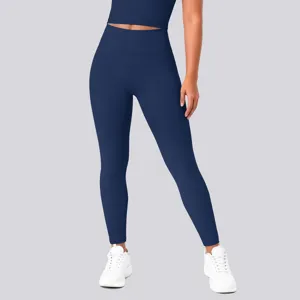 High waist detail of solid dark blue yoga leggings and crop top set, athletic fitness sportswear.