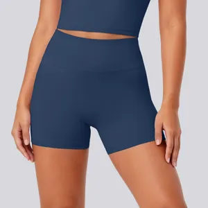Detail view of dark blue high-waisted yoga shorts and sports top, breathable and elastic.