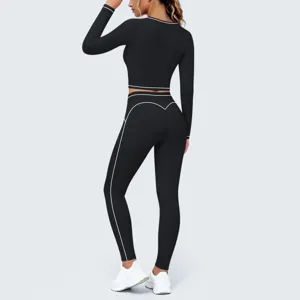 Black long sleeve crop top leggings yoga set with white contrast piping for fitness training.