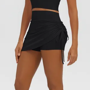 Detail view of black high waist ruched fake two-piece yoga skirt, stretchy fitness athletic shorts.