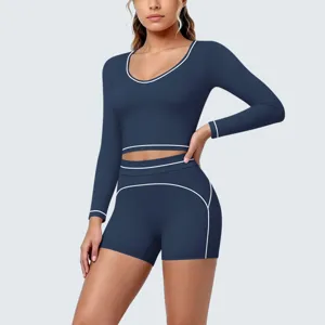 Dark blue long sleeve crop top and shorts activewear yoga set with white contrast piping.