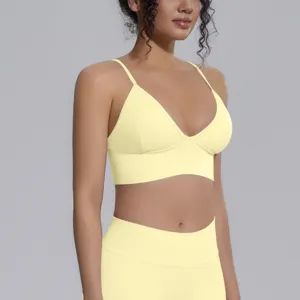 Seamless yellow sports bra yoga top detailed view, stretchy breathable fitness activewear.