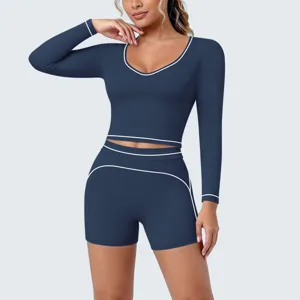 Dark blue long sleeve cropped yoga top and shorts set with white piping trim for daily workout.