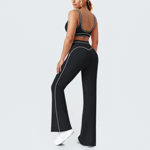 Set composto da reggiseno sportivo nero e pantaloni yoga a zampa, vista laterale dettagliata.