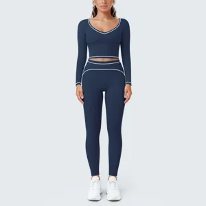 Detailed view of navy blue yoga set with white contrast trim and long sleeve crop top.