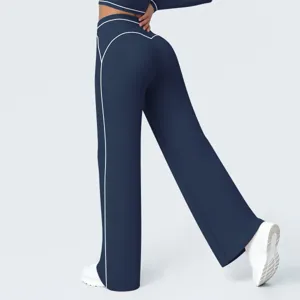 Detail view of high-waist wide-leg athletic pants with contrast white piping design.