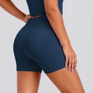 Detail shot of high-waisted dark blue yoga shorts showing tight fit and elastic waist design.