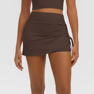 Detailed view of women high waist side ruched athletic skort in dark brown, breathable active wear.