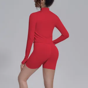 Red seamless long sleeve crop top and biker shorts activewear set for fitness and yoga.