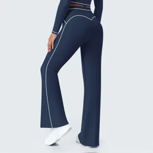 Close-up detail of dark blue high-waisted flare yoga pants with white contrast piping.