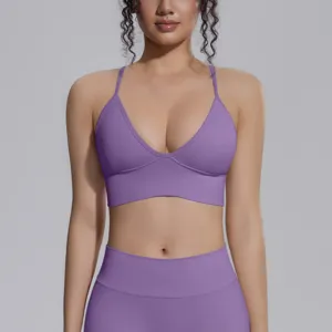 Detail shot of purple seamless sports bra and yoga pants, high elasticity breathable fitness wear.